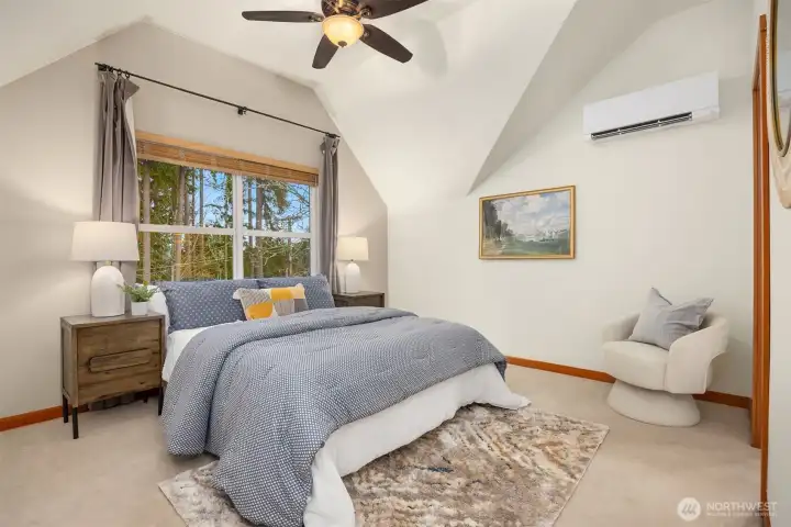 The primary bedroom features vaulted ceilings, a ceiling fan, and a walk-in closet.