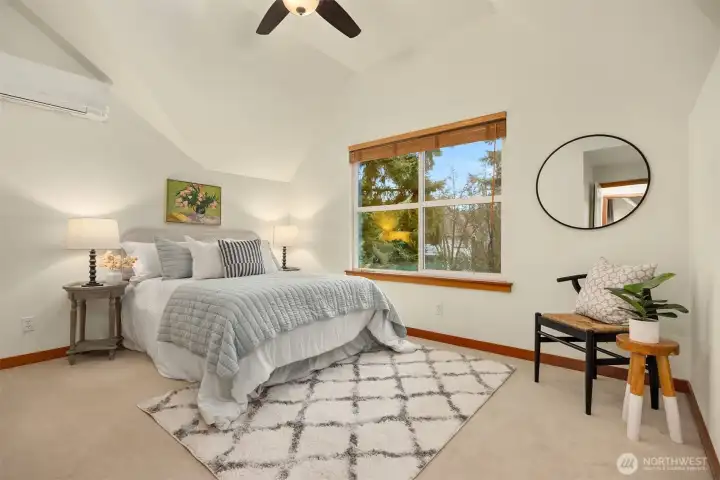 The second bedroom also features a ceiling fan, vaulted ceilings and a private bathroom.