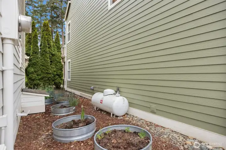 The shared garden beds makes a great spot to plant herbs or veggies.  A home generator is also shared with the neighbor to the east.
