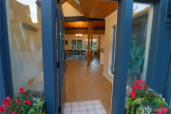 Step through the front door and the lake greets you straight ahead. The warm glow of the interior through those windows at dusk is a preview of what life here feels like every single evening.