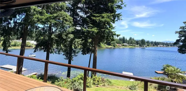 The massive new composite deck frames an unobstructed panoramic view of Lake Meridian. Access the deck from two sliders in the main living area and from the primary bedroom. Watch the eagles in the trees above. This is where summer happens.