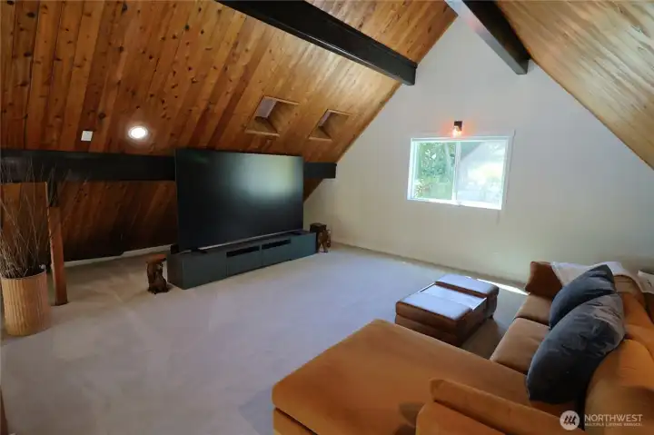 The loft is currently used as a media lounge with wood beam ceilings and room to sprawl out and watch the big screen in total comfort. Movie nights at the lake just got a serious upgrade.