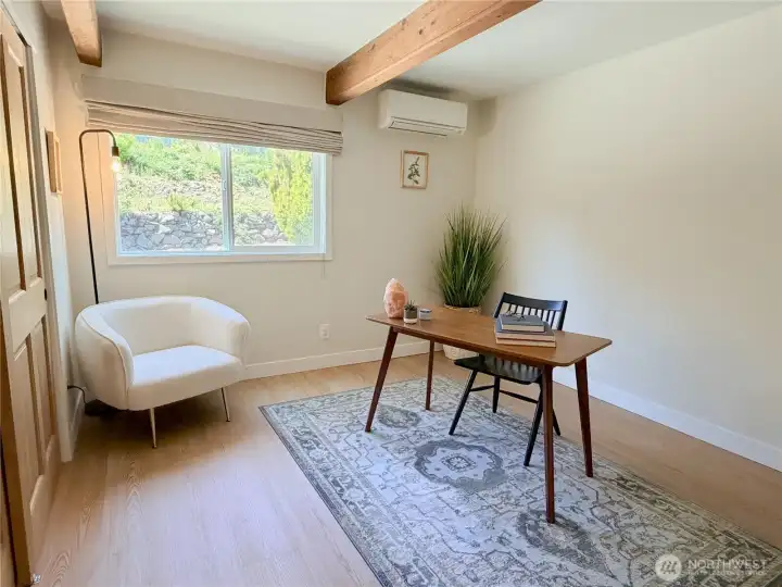 A quiet main-level office or flex room with wood beam ceiling, closet, mini split, and no neighbor in your view gives you the perfect work from home setup. Or use it as a main level bedroom. The layout truly works for everyone.