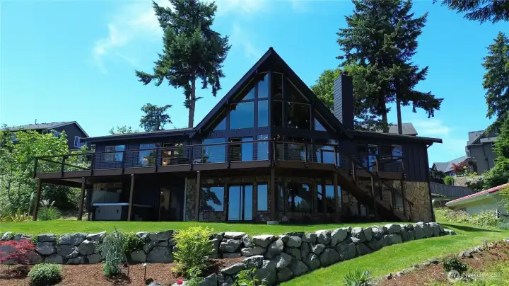 Over half an acre of beautifully landscaped, terraced grounds lead down to the lake. Stone accents, a sweeping multi-level deck, lush landscaping, and that iconic A-frame silhouette make this one of the most architecturally stunning homes on Lake Meridian.