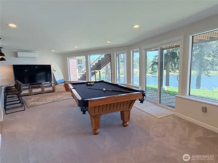Panoramic lake views from the lower level mean the whole family gets the waterfront experience, not just the main floor. This enormous room with its own mini split has space for everything.