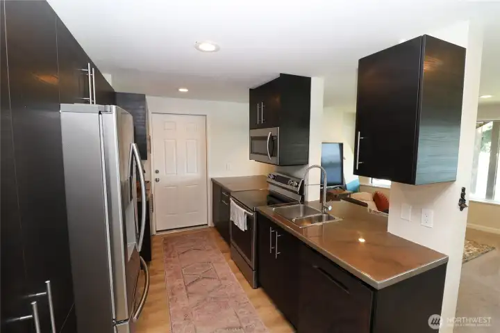 A complete second kitchen in the daylight basement means total independence for guests, family, or tenants. With its own separate entrance, garage, and stunning lake views just beyond, this space is ready to earn its keep from day one. All appliances convey.