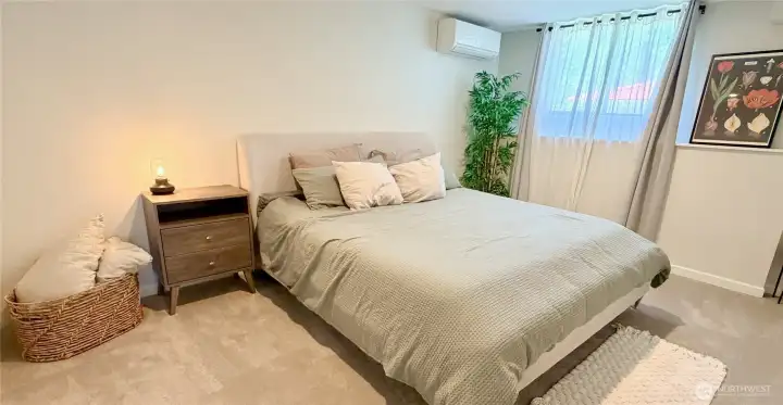 A beautifully appointed second lower level bedroom with its own mini split for year-round comfort. Part of the daylight basement suite with a separate entry, full kitchen, and lake views, ideal for guests, family, or rental income.