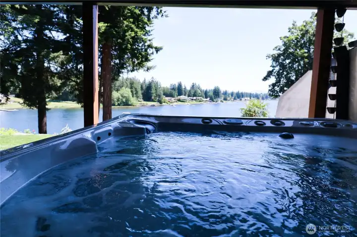 Pure magic morning or night. The covered hot tub looks directly out over Lake Meridian, where eagles visit and the water sparkles just beyond your fingertips.