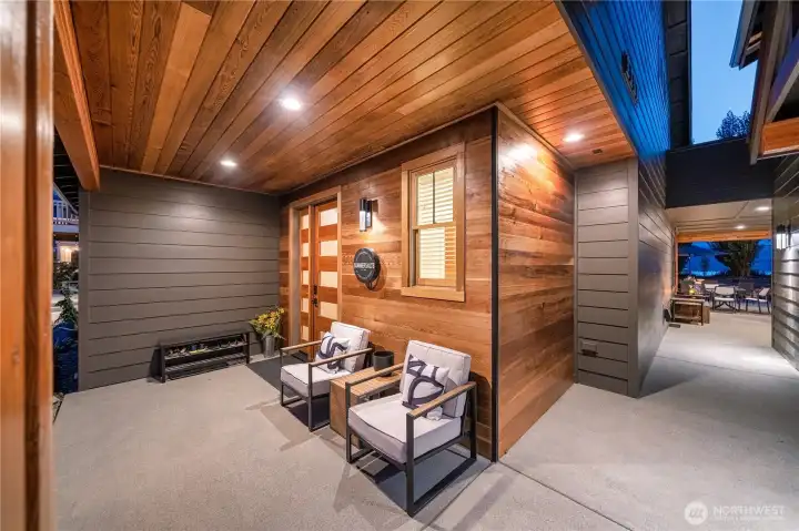 View of entryway with cedar soffits and breezeway between the main house and adjacent garage and carriage house.