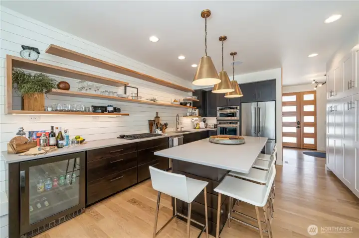 Kitchen with quartz countertops, high-end appliances, and sit up kitchen island.