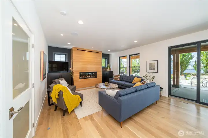 Main level living room with glass sliding doors leading to the outdoor living area.