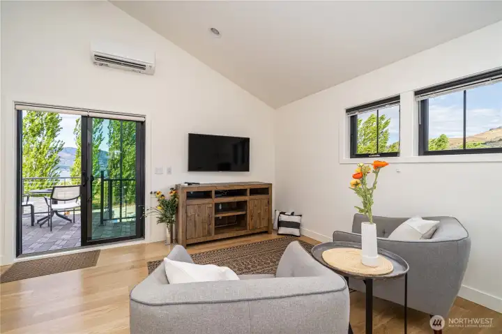 ADU/Carriage House living room area with glass sliding doors leading to the lake view deck.