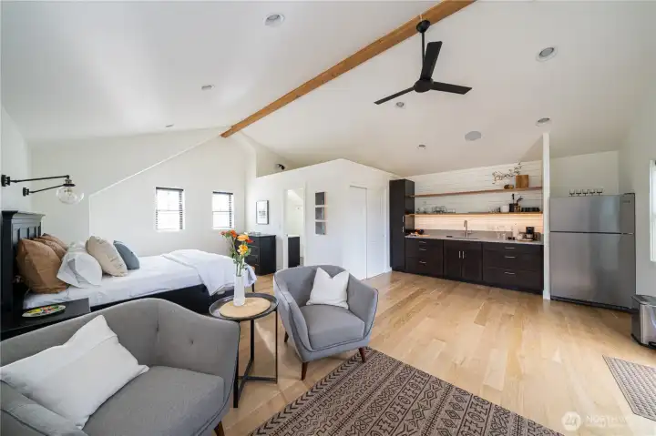 ADU/Carriage House studio with kitchenette, living room, bathoom and glass sliding doors leading to the lake view deck.