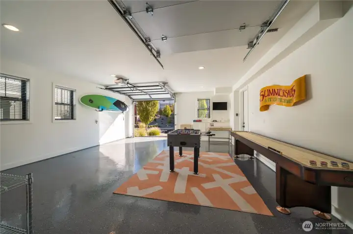 Detached finished 1-car garage with half game/rec room area plus room for a single car.