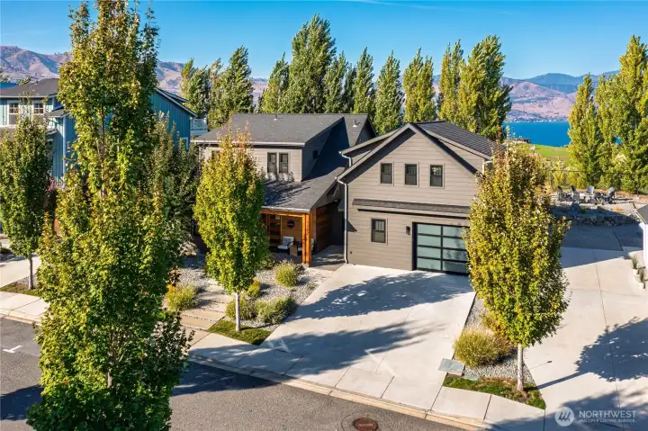 Exterior view of the front of the home with 1-car garage and carriage house.