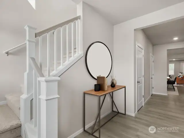 Inviting entry with open railings, large closet and 2ndary pantry/storage, . “Photos are for representational purposes only. Colors and options may vary”