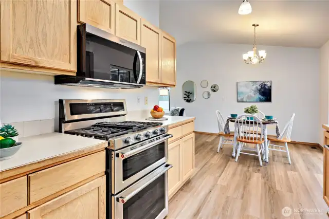 Kitchen with natural gas range, double ovens.