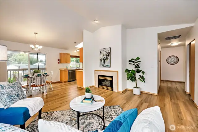 Cozy natural gas fireplace and open concept living room flows to dining room and kitchen.