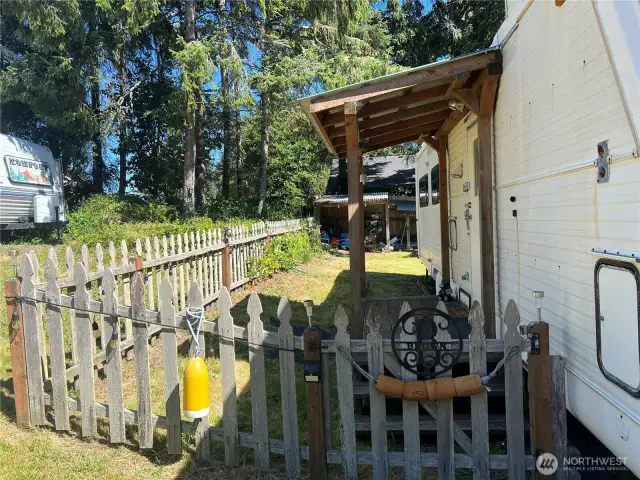 Fenced entry to keep your furry companions safe. Covered porch to enter the 5th wheel.