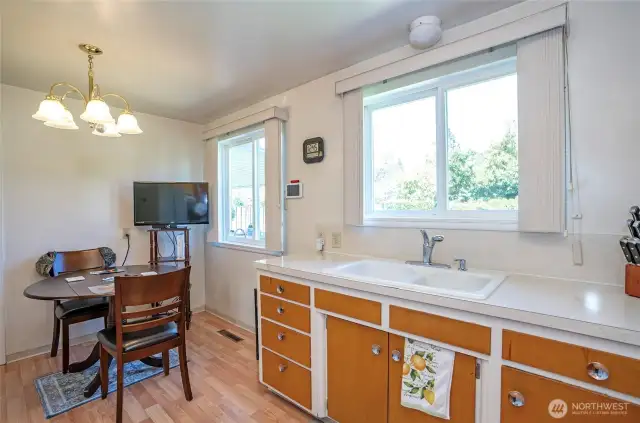 Dining area with a lovely window overlooking the lush, private backyard.
