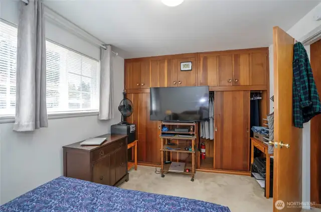 Enjoy the beauty and function of a built-in closet and storage system crafted in rich wood, right in the primary suite.