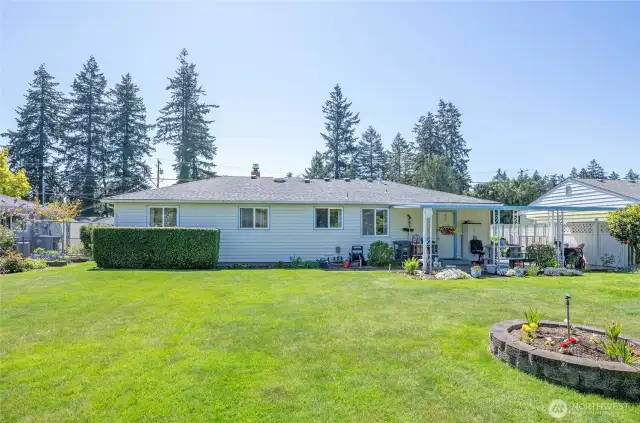 Looking back at the home from the peaceful backyard setting.