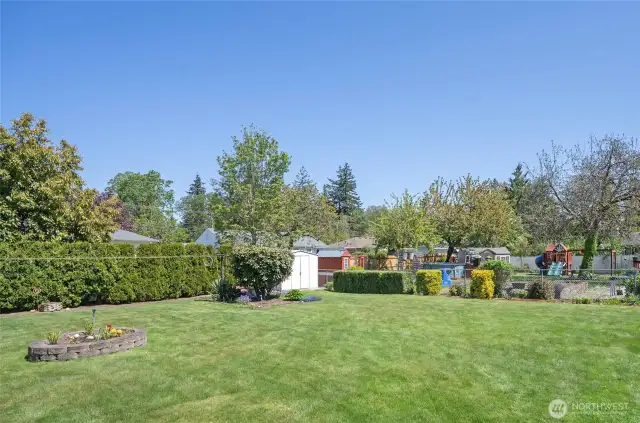 Another angle of the beautifully maintained, fenced backyard—perfect for play, pets, or peaceful relaxation.