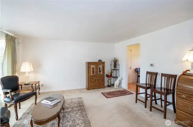 A fresh angle of the living area, with easy access through the doorway to the kitchen and dining room.
