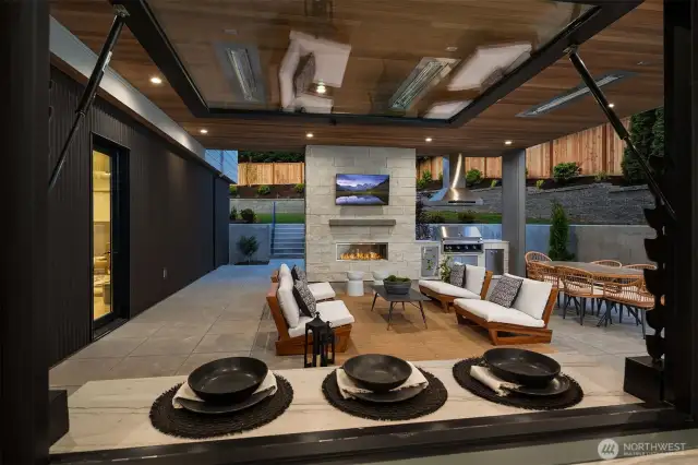 Outdoor covered living area with fireplace & BBQ