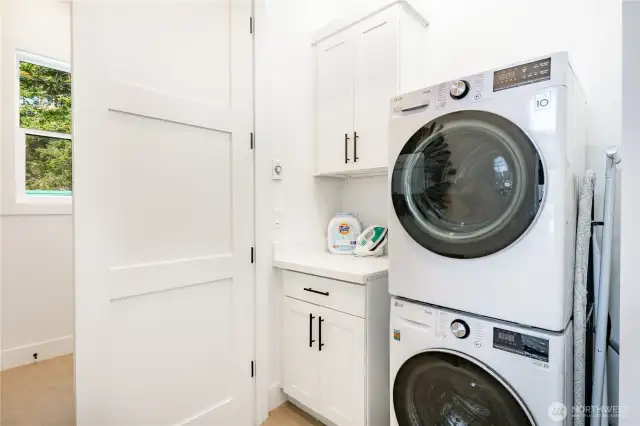 Laundry on third level adjacent to two bedrooms.