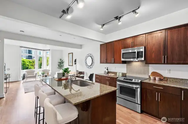 Enjoy a spacious island with granite counters, SS appliances, and plenty of storage.