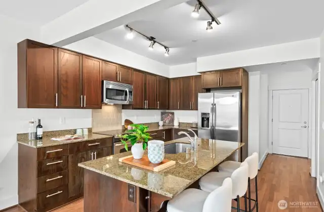 Chef's kitchen with granite counters, SS appliances, and refinished cabinets.