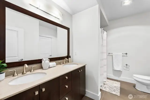 Spacious full bathroom with dual vanity sinks. The bathroom has access from both the bedroom and the main living area.