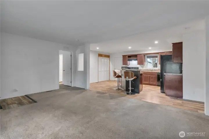 Open plan leading to kitchen, dining and laundry closet