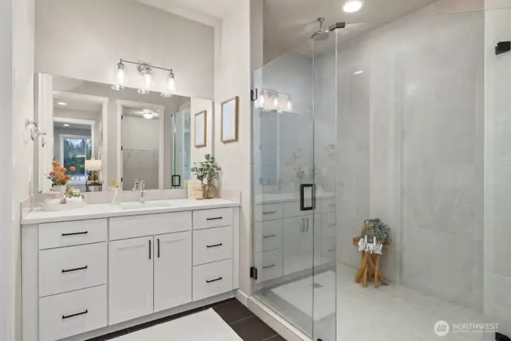 Luxurious bathroom in Owner's Suite with double vanity and walk-in shower.
