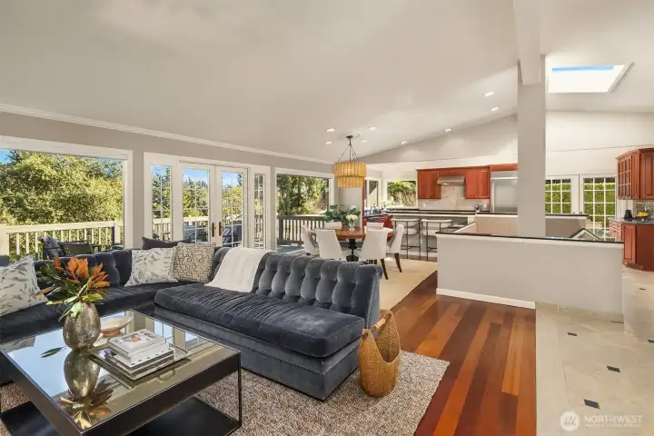 The main floor strikes a perfect balance of warmth and refinement: gleaming white millwork, rich hardwood floors, and strong stone countertops set a tone that is both timeless and fresh.