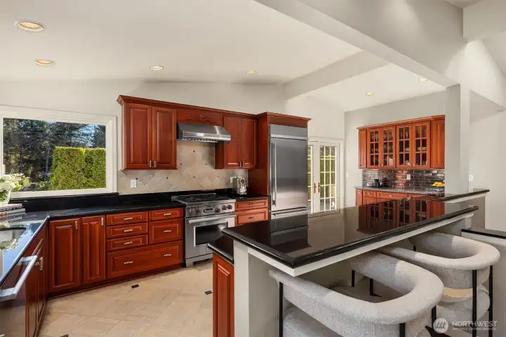 Cherry wood brings added warmth to this kitchen with plenty of natural light. The perfect blend to start your day.