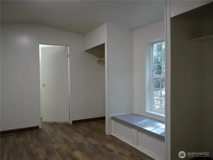 Primary Bedroom with Attached Full Bathroom. Sunny Seated Storage Bench