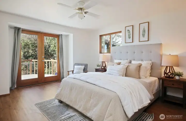 Primary bedroom has French Doors that lead to the front deck.