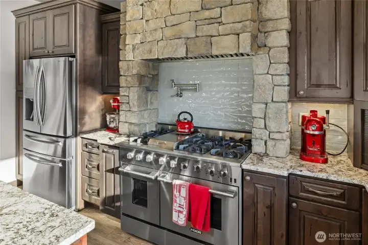 High end appliances with custom stone work and knotty alder cabinets makes this kitchen a place for everyone to enjoy. The chef would not be lonely in this kitchen. Visitors can hang out at the massive center island to enjoy the surroundings.