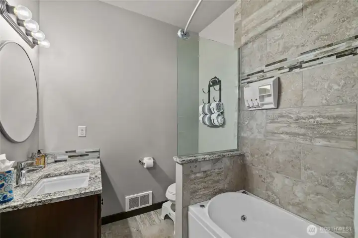 Beautiful custom tile bathroom for main floor bedrooms.