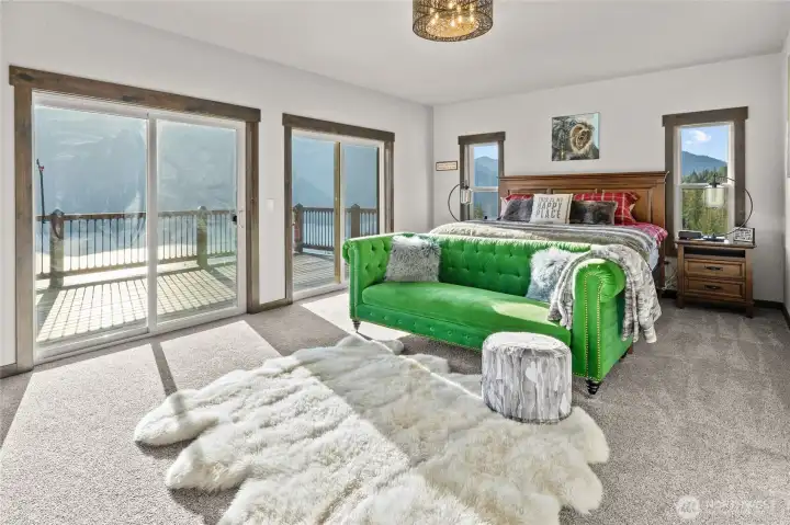 Primary bedroom is on the main floor with a massive view of the mountains and lake Cle Elum. Just imagine waking up to this view!
