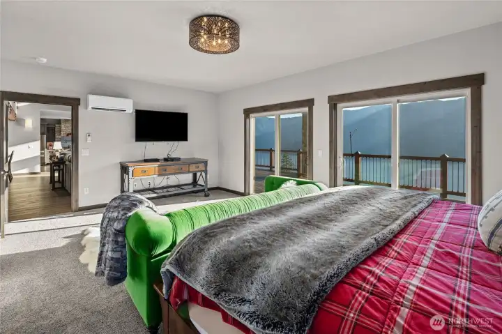 The primary bedroom is elegant, w/ huge views and sliding doors to the deck just outside your bedroom door.