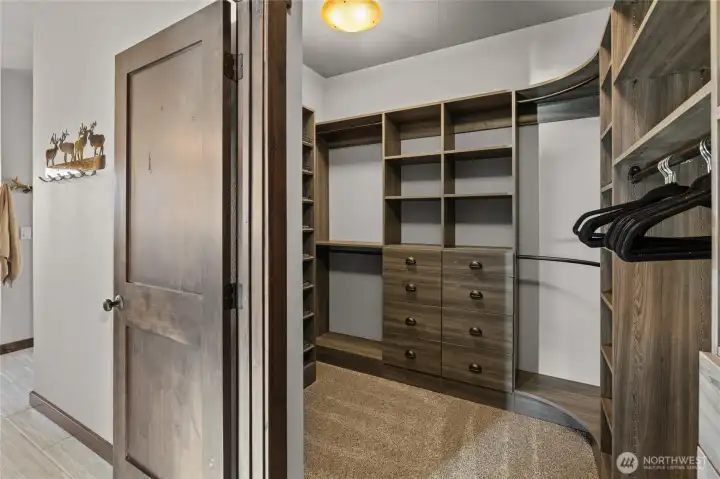 The primary bedroom closet has custom organizer for the ease of storing your clothes.