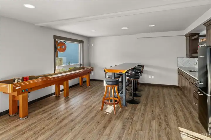 A view of the down stairs game room area, with a full bar. Fun for everyone.
