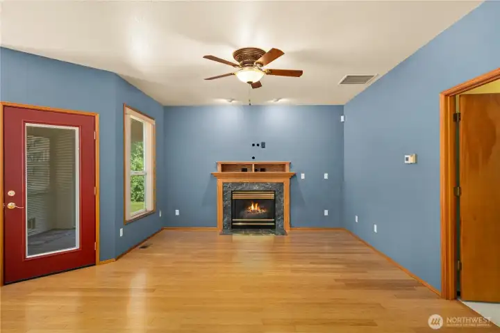 Open living and dining area with gas fireplace and comfortable flow between spaces