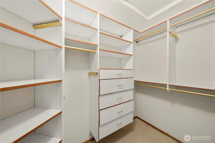 Large walk-in closet with custom built-ins and abundant storage space