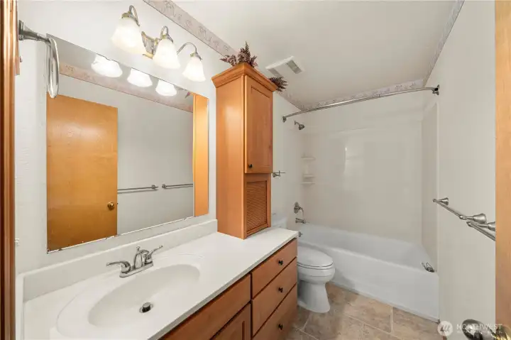 Hall bath with oversized vanity and tub/shower combination