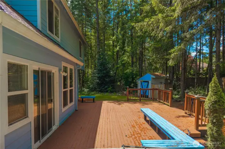 Private backyard deck surrounded by peaceful natural scenery