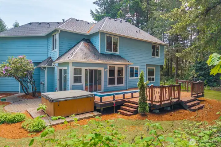 Expansive deck overlooking the private backyard and surrounding natural setting